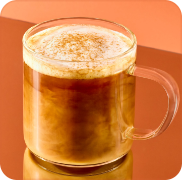 Glass mug of iced coffee with a handle on an orange background