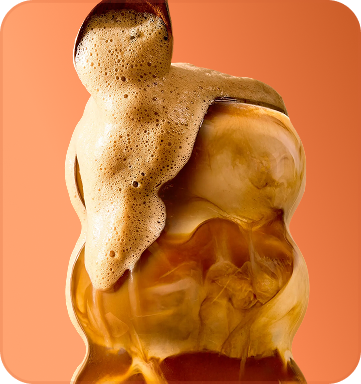 Close-up of a layered dessert with coffee and cream on an orange background